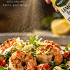 Mantova Sicilian Lemon Extra Virgin Olive Oil Spray misting a shrimp salad
