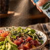 Mantova Poke Soy Sauce Spray misting a fresh poke bowl